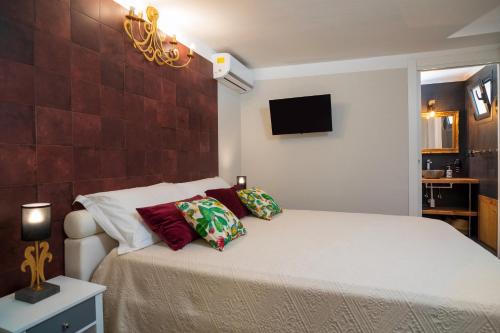 a bedroom with a bed with two pillows on it at A Ugghia in Fiumefreddo di Sicilia