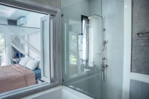 a bathroom with a shower and a sink with a glass door at Villa Cannes with gym and tennis court in Choeng Mon Beach