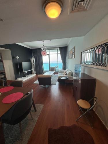 a living room with a couch and a table at Blue Horizon Stays at Ajman Corniche in Ajman