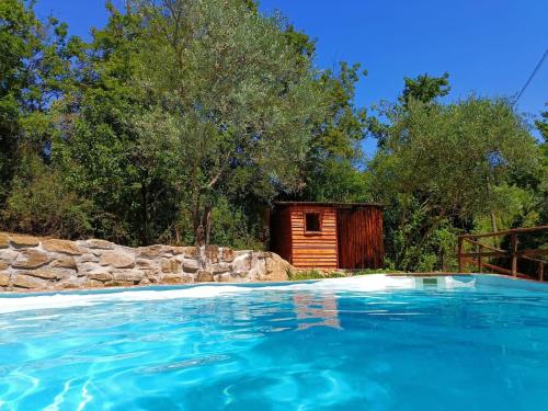 a small wooden cabin with a pool in front of it at Country home in the Chiantishire close to Florence in L'Ugolino