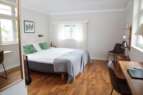 a bedroom with a bed and a desk at STF Hotel Zinkensdamm in Stockholm