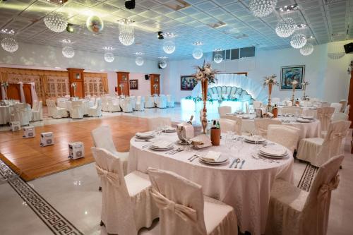 a banquet hall with white tables and white chairs at Marina Frapa Resort Rogoznica in Rogoznica