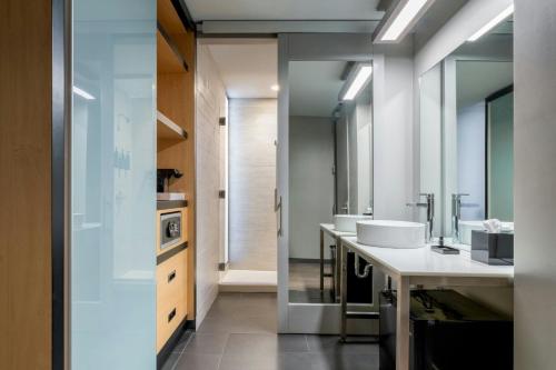 a bathroom with two sinks and two mirrors at Aloft Columbia Downtown in Columbia