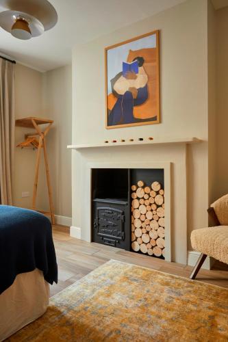 a living room with a fireplace and a painting at Georgian House Hotel in London