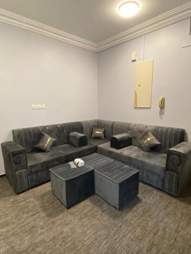 a living room with a couch and a coffee table at Al Rayhan Suites الريحان للأجنحة المفروشة in Al Madinah