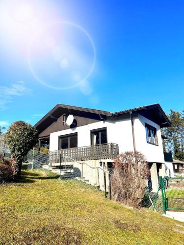 a white house with a black roof at Chalet Wienerwald in Königstetten