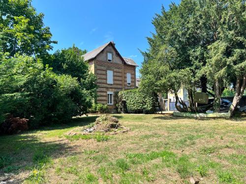 a house in a yard with trees and grass at Loveroom en bords de Meuse in Floing