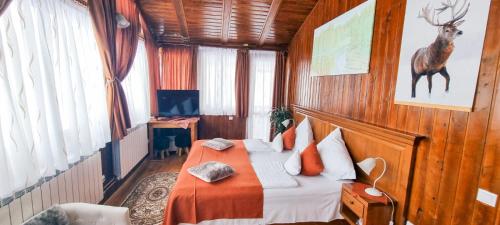 a bedroom with a bed with a deer on the wall at Cabana Bâlea Lac in Cîrţişoara