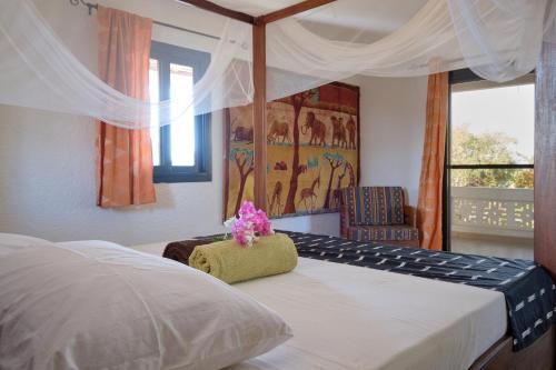 a bedroom with a bed with flowers on it at Suite vue mer in Mar Lodj