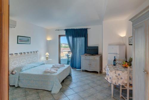a bedroom with a bed and a table and a television at Relaxing Residenzia Palau Green 1 Bedroom Apartment B4 4 Person in Palau