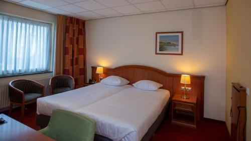 Ein Bett oder Betten in einem Zimmer der Unterkunft Parkhotel Valkenburg