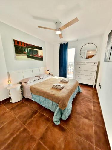 a bedroom with a bed and a dresser at Casa Kusama in Corralejo