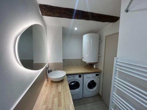 a small bathroom with a washing machine and a sink at Superbe T2 Bolquère in Bolquere Pyrenees 2000