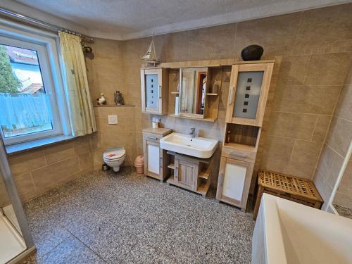 a bathroom with a sink and a toilet at Gehlberger Landhaus am Schneekopf / Ferienwohnung in Suhl