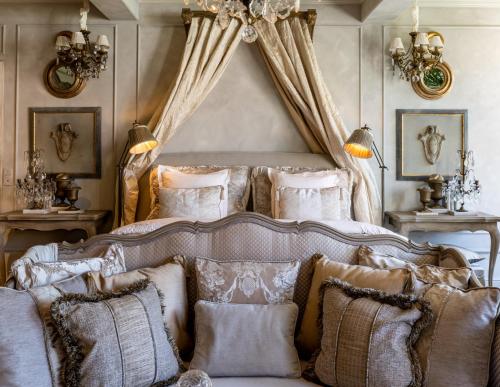 a bedroom with a large bed with pillows at The Notary in Bruges