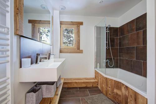 une salle de bain avec un lavabo, une baignoire et une douche dans l'établissement Les Flocons Dorés - Chalet sur le chemin des pistes, à Formiguères