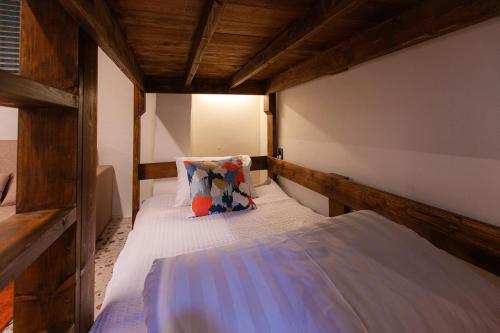 a small bedroom with a bed with a pillow at Hostel Mihojae Seomyeon in Busan