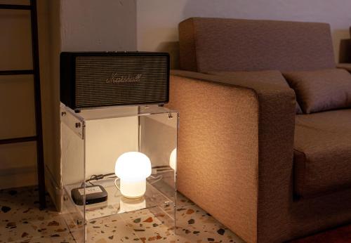 a television on top of a glass table next to a couch at Hostel Mihojae Seomyeon in Busan