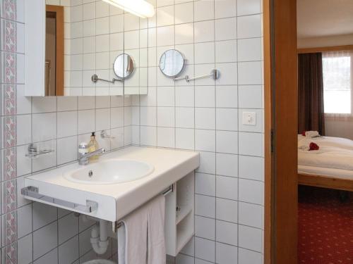 a white bathroom with a sink and a mirror at Apartment Chalet Abendrot apARTments-30 by Interhome in Grindelwald
