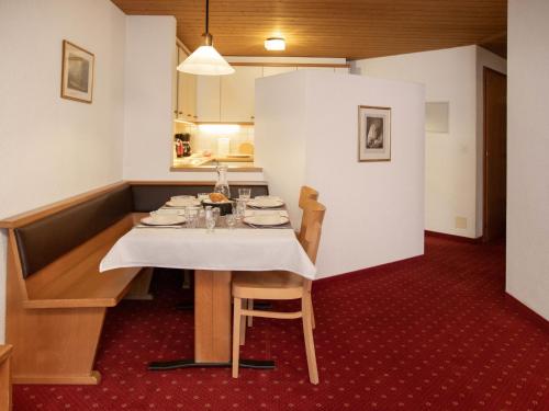 a dining room table with a white table cloth on it at Apartment Chalet Abendrot apARTments-25 by Interhome in Grindelwald