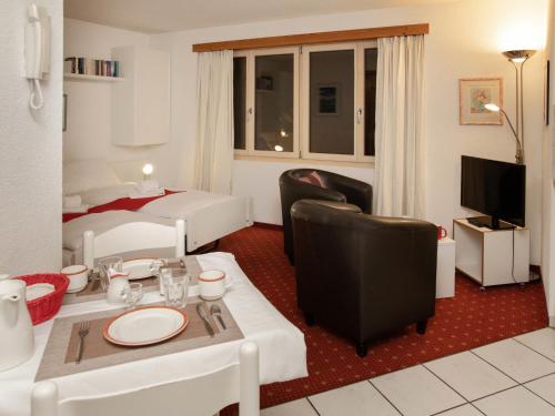 a living room with a bed and a room with a table and chairs at Apartment Chalet Abendrot apARTments-6 by Interhome in Grindelwald