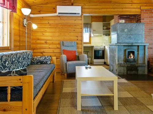 uma sala de estar com um sofá e uma lareira em Holiday Home Aittoniemi ii by Interhome em Hopsu