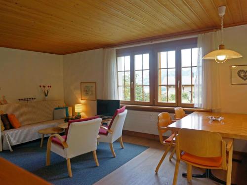 a living room with a table and chairs at Apartment Zapfe - Küenzi by Interhome in Saanenmöser