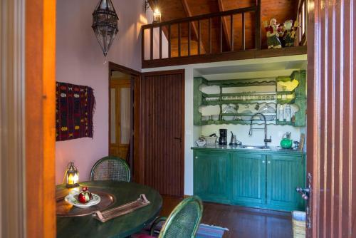 a dining room with a table and a kitchen at Dandy Villas Amfiklia - Guest House Dafne - Garden in Amfiklia