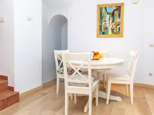 a dining room with a white table and chairs at Apartment Gregal by Interhome in Tossa de Mar