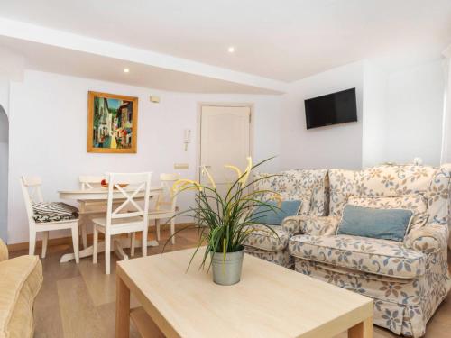 a living room with a couch and a table at Apartment Gregal by Interhome in Tossa de Mar