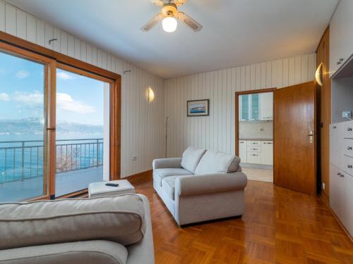 a living room with two couches and a large window at Holiday Home Robert by Interhome in Trogir