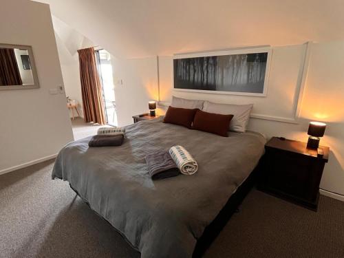 a bedroom with a large bed with two pillows on it at Alella by the sea in Gnarabup