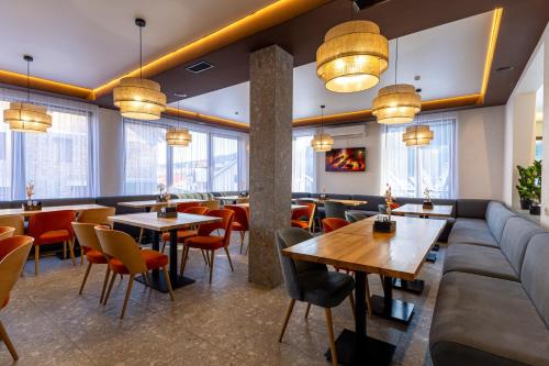 a restaurant with couches and tables and chairs at Milli&Jon SPA in Bukovel