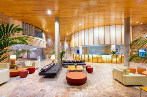 a lobby with couches and tables in a building at MUR Faro Jandia Fuerteventura & Spa in Morro del Jable