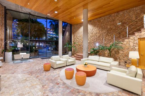 a lobby with couches and a table in a building at MUR Faro Jandia Fuerteventura & Spa in Morro del Jable