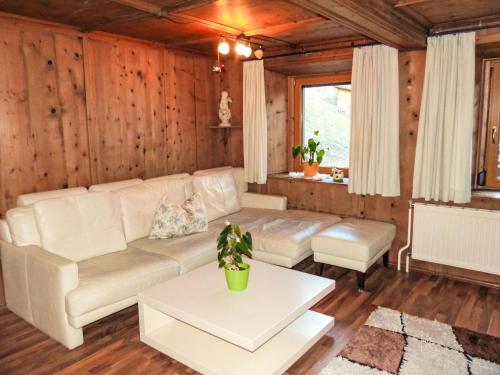 a living room with a couch and a table at Apartment Winklerhof - Bergblick by Interhome in Oetz