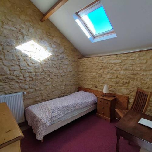 une petite chambre avec un lit et une fenêtre dans l'établissement La Gardelle, à Groléjac