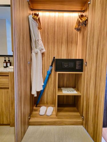 a cabinet with an umbrella and shoes in a room at Super Studio La Vita 2 pool in Rawai Beach