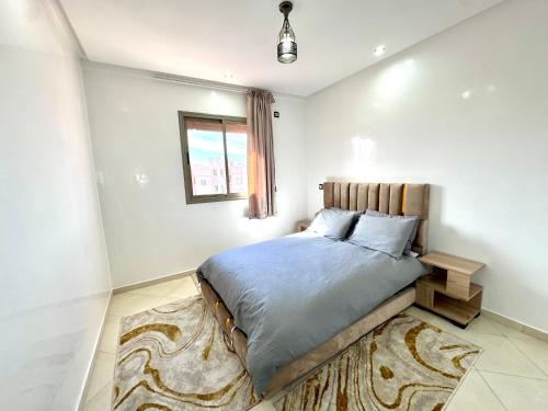 a bedroom with a bed and a rug at RENTSUITE SPACIOUS and COMFY 2 BEDROOM in Marrakech