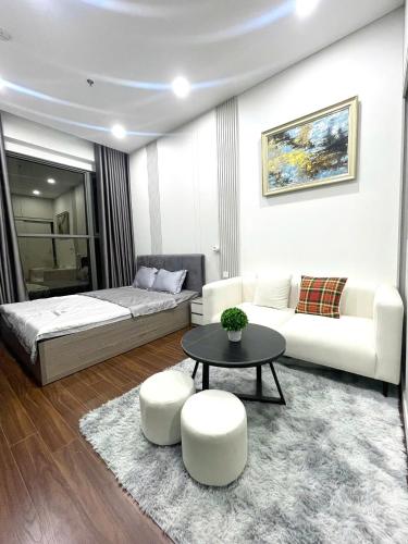 a bedroom with a bed and a couch and a table at Vinhomes Ocean Park , Gia Lâm , Hà Nội in Gia Lâm Pho