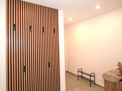 a room with a closet with a bench next to it at Apartment Wibmer by Interhome in Axams