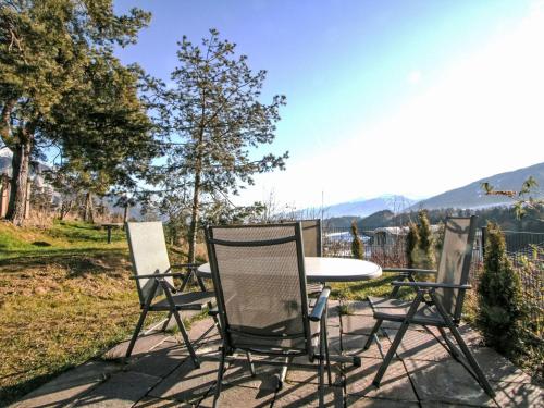 a table and chairs on a patio with a view at Apartment Wibmer by Interhome in Axams