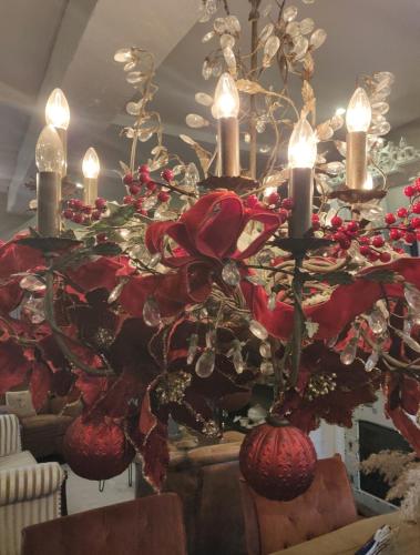 a chandelier with red flowers and candles in a room at Auberge de La Chaloire in La Petite-Verrière