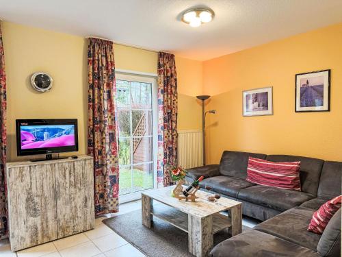 a living room with a couch and a tv at Holiday Home Haus Nr- 14 by Interhome in Lenz