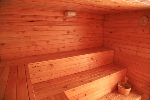 a wooden sauna with a bench in it at The Giraffe Cottages in Nairobi