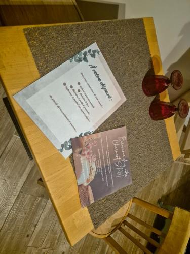 a table with two cards on top of it at Le Charmant Spa in Chauny