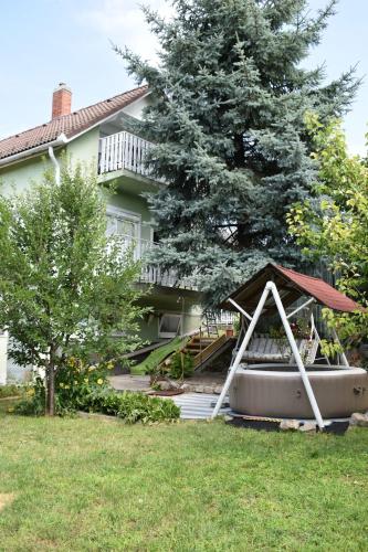 a house with a boat sitting in the yard at Kuczkó Apartman in Balatonalmádi
