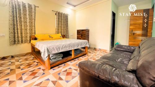 a living room with a bed and a couch at StayMist - Ocean Lemon Pool Villa with Jacuzzi in Alibaug