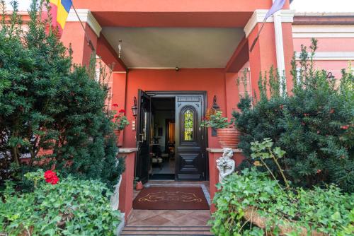 an orange house with a black front door at Casa del Sole Boutique Hotel Timisoara in Timişoara