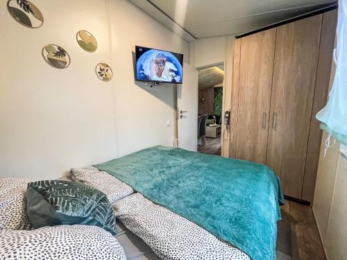 a room with a bed and a tv on the wall at Holiday Home Tiny Haus Tiny Moments by Interhome in Wemding